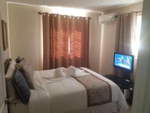 Postel nebo postele na pokoji v ubytování Ridgeview Suites 1 to 3