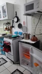 a kitchen with a stove top oven in a kitchen at Casa Luz Mi casa tu casa in Sabanitas