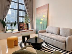 a living room with a couch and a table at EkoCheras Designer Suite by Moka @ Cheras in Kuala Lumpur