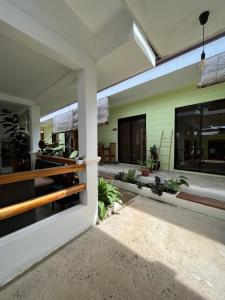 an indoor courtyard of a house with plants at Hutch Lodging House in El Nido