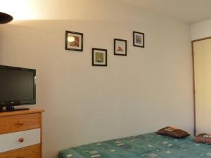 a bedroom with a television and pictures on the wall at Saint Pierre la Mer, Appt 2 pièces, cabine, 6 couchages, près plage, animaux OK - FR-1-229D-249 in Saint Pierre La Mer