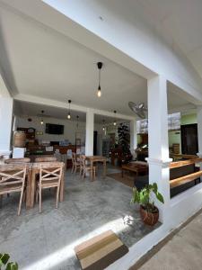 a dining room and living room with a table and chairs at Hutch Lodging House in El Nido
