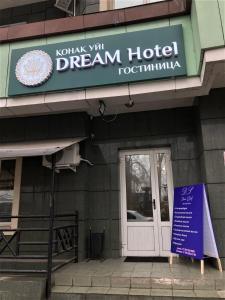 a dream hotel with a sign in front of a door at Dream Hotel in Almaty