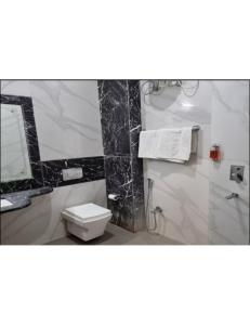 La salle de bains est pourvue de toilettes blanches et d'un miroir. dans l'établissement Hill Home Stay, Mankhim Road, Aritar, Sikkim, à Aritar