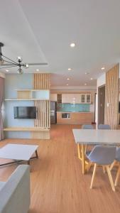 een keuken en een woonkamer met een tafel en stoelen bij Oceanus Oasis Retreat Muong Thanh Vien Trieu in Nha Trang
