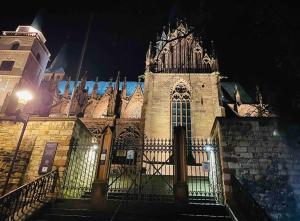 a building with a gate in front of it at night at Altstadt pur! An der schönen Katharinenkirche in Oppenheim +6 photos