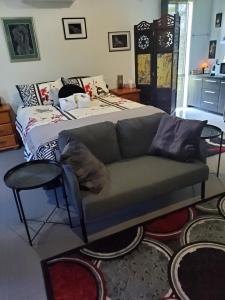 a living room with a couch and a bed at Green Acres B&B in Beechmont