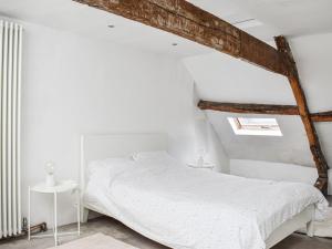 a white bedroom with a white bed and a white wall at Market Place View in Knaresborough