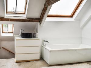 a bathroom with a sink and a bath tub at Market Place View in Knaresborough