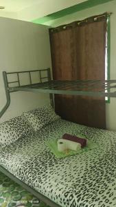 a bedroom with a bunk bed with a cheetah print bedspread at Ustaris Homestay in Itaytay