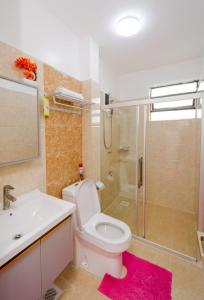 a bathroom with a toilet and a sink and a shower at Lux Suites Sandalwood Furnished Apartments in Nairobi