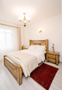 a bedroom with a large bed and a red rug at Lux Suites Sandalwood Furnished Apartments in Nairobi