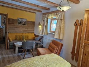 a bedroom with a bed and a couch at Badhaus in Achenkirch