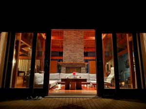 een woonkamer met een bank en een open haard bij Private beach retreat Resort villa iki by ritomaru in Iki