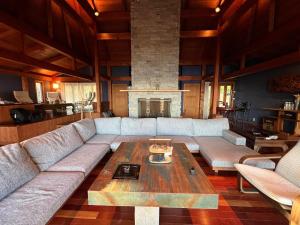 a living room with a couch and a coffee table at Private beach retreat Resort villa iki by ritomaru in Iki
