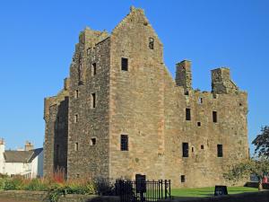 an old stone castle with a blue sky in the background at Charming 3BR Flat in Beautiful Kirkcudbright in Kirkcudbright