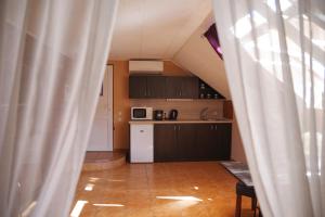 a kitchen with a white refrigerator and a table at Apartmány Novákovi U NOVAČKY in Nechanice