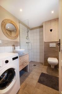 a bathroom with a washing machine and a sink at Le Gite de Noemie in Mercury