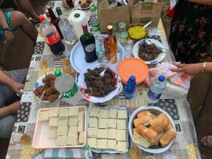 Kazkreole في Mont Blanc: طاولة مع الطعام والمشروبات وأطباق الطعام