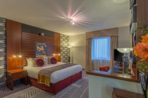 a hotel room with a bed and a television at Crowne Plaza Dublin Airport, an IHG Hotel in Santry
