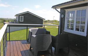 a deck with two chairs and a window at Holiday Home Bagenkop With Fireplace 05 in Bagenkop +20 photos