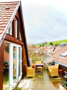 a balcony with chairs and a table on a building at Schönster Blick auf Oppenheim! in Oppenheim