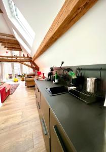 a kitchen with a black counter top and wooden floors at Schönster Blick auf Oppenheim! in Oppenheim