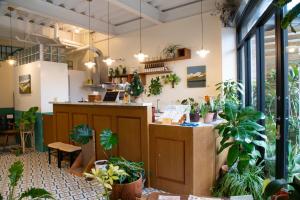 a restaurant with potted plants and a counter at Lixia Hostel in Xiaoliuqiu