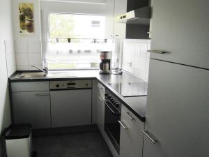 a kitchen with a sink and a stove top oven at Ferienwohnung Schliestädt-Görge in Lindau