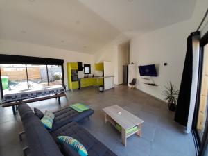 a living room with a couch and a table at Irfanell in Saint-Louis