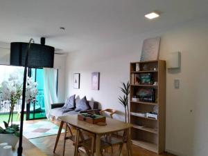 a living room with a table and a couch at RDR Homestay@Emira Residence in Shah Alam