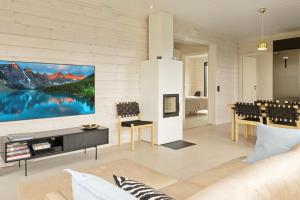 a living room with a large painting on the wall at Villa Horihane - Modern Villa with panoramic view in Ivalo