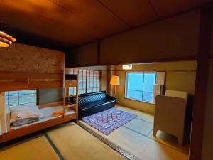a small room with two bunk beds and a couch at SOUQ越後湯沢 in Yuzawa