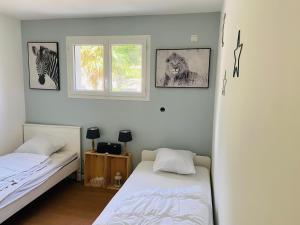 Ένα ή περισσότερα κρεβάτια σε δωμάτιο στο Villa soulac 6 chambres, wifi