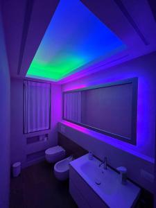 a bathroom with a purple and green lighting at Relax in Milano - Ventura - Lambrate - Città Studi in Milan