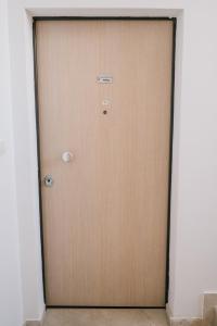 a brown door with a sign on it at Apartman PETRA in Trogir
