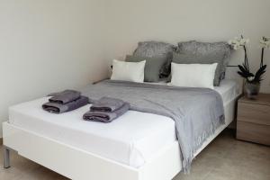 a bedroom with a white bed with towels on it at Stunning 1BDR Sliema-Center Penthouse! Near POOL! in Sliema