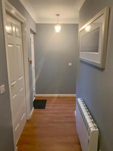 an empty hallway with a radiator and a door at Brada View Bamburgh in Bamburgh