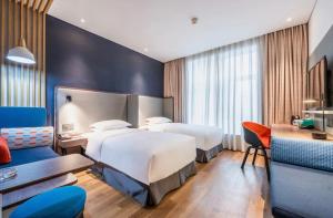 Postel nebo postele na pokoji v ubytování Holiday Inn Express Hefei Shushan by IHG
