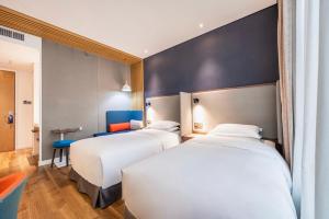 Postel nebo postele na pokoji v ubytování Holiday Inn Express Hefei Shushan by IHG