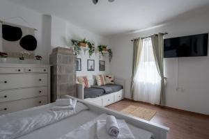 a bedroom with a bed and a dresser at Zemplén Gyöngye Vendégház in Erdőhorváti