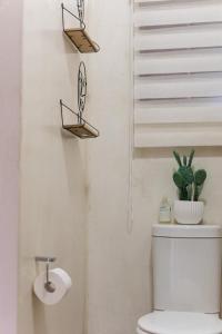 a white bathroom with a toilet and a staircase at Mariù Upmarket Accommodation in Nelspruit