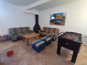a living room with couches and a table with a chessboard at La casa del olivo en Córdoba in Córdoba