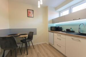 A kitchen or kitchenette at PontJó Apartman Miskolc