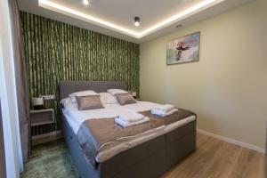 A bed or beds in a room at PontJó Apartman Miskolc