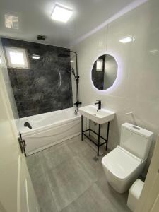 a bathroom with a toilet and a sink and a tub at ART HOUSE 33 in Kutaisi +63 photos
