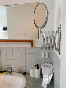 a bathroom with a mirror and a sink at Apartmány u Arény Ostrava in Ostrava