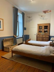 a bedroom with two beds and a window at La ferme de Basseilles in Mozet  +59 photos