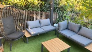 a patio with two chairs and a couch and a table at LaCabane in Cormondreche