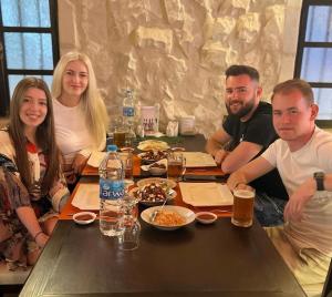 a group of people sitting at a table with food at Mount Nebo Hotel & Restaurant Madaba City Center in Madaba